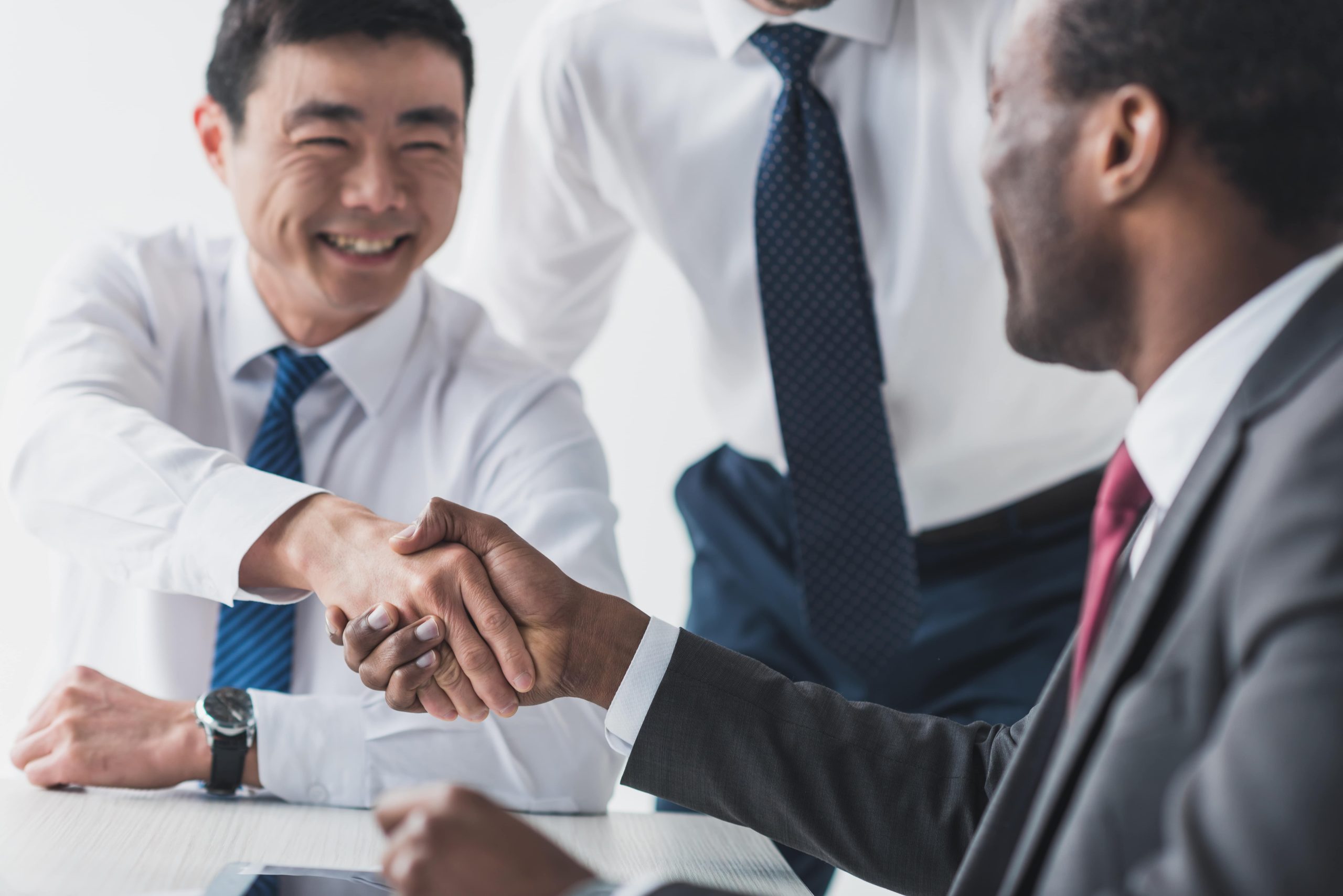 Multiethnic businessmen shaking hands